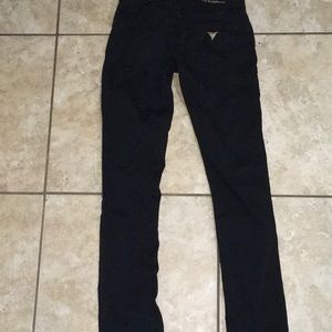 Black Guess premium pants. Boot cut. Gold decal.